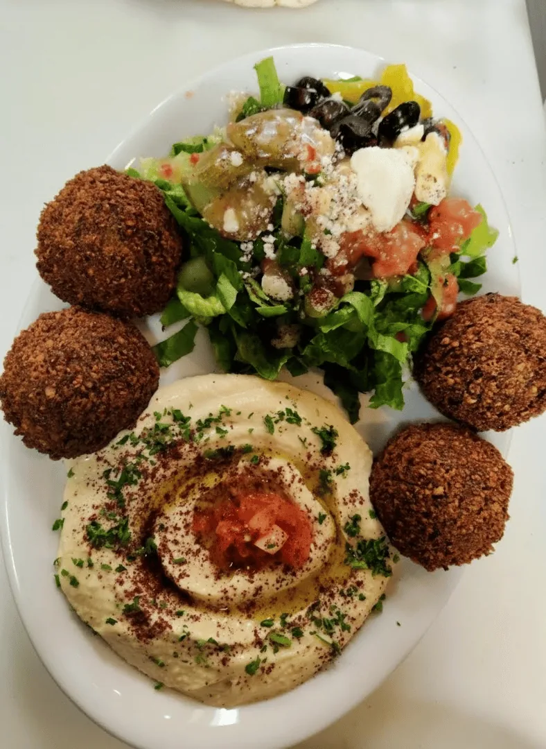 Golden fried falafel served with lettuce and tahini at Mirage Mediterranean in Louisville