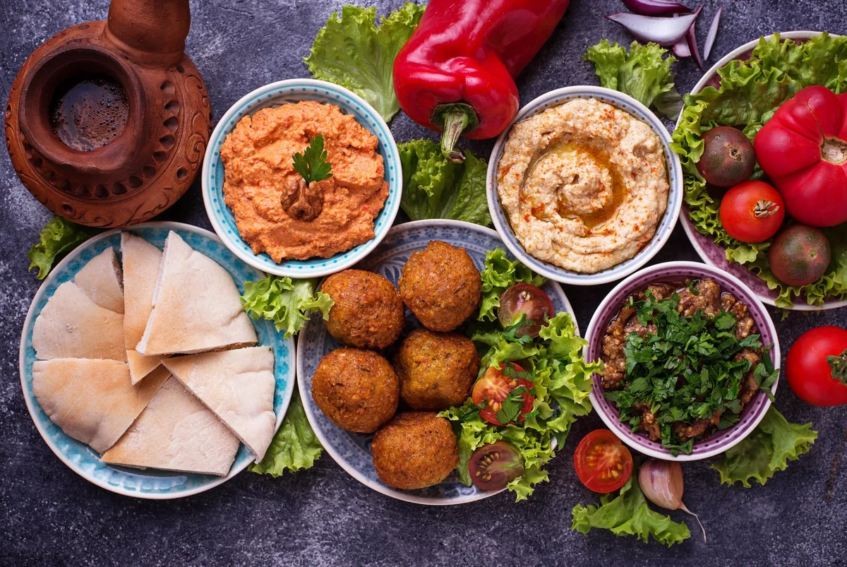 Falafel, hummus, pita and muhammara arranged on a table at Mirage Mediterranean near Louisville airport