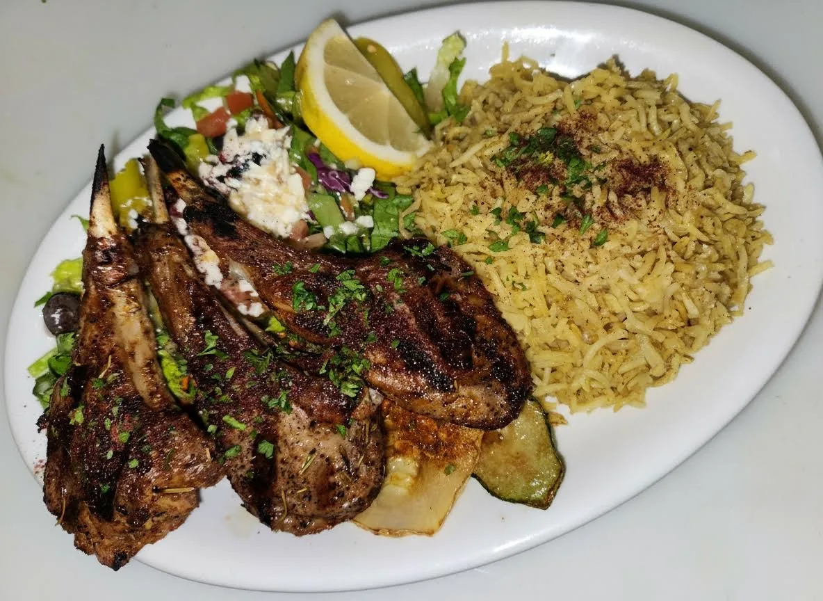 Grilled lamb chops served with rice and vegetables at Mirage Mediterranean in Louisville