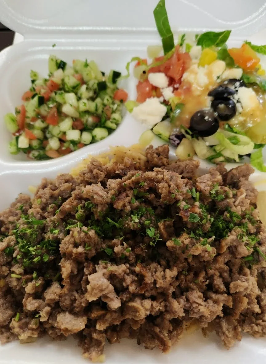 A gyro plate with beef and lamb gyro meat, rice and grilled vegetables at Mirage Mediterranean